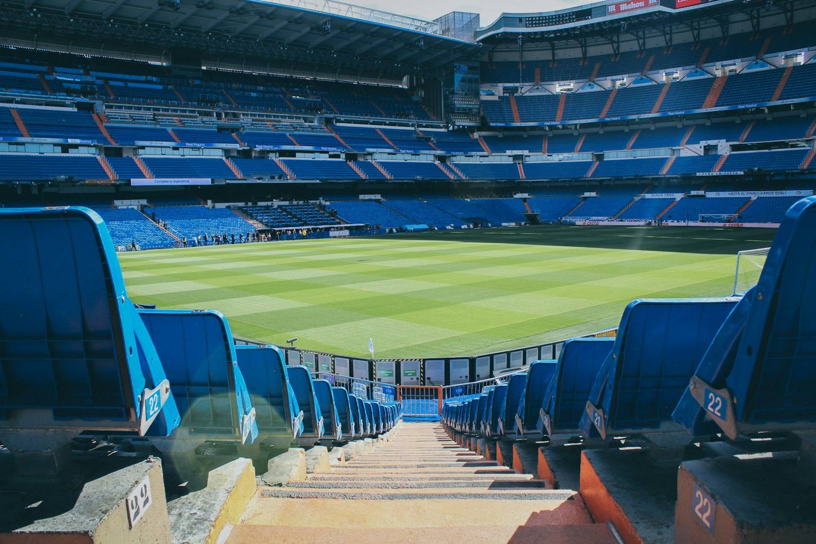 Empty football stadium seating on a sunny day